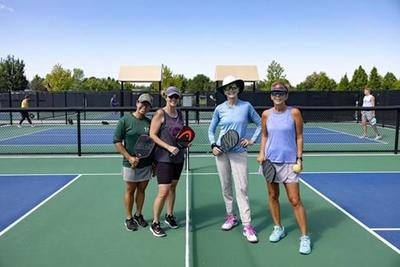 Doubles play on an outdoor pickleball court